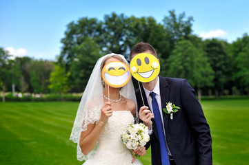 bride and groom with paper smileys