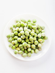frozen peas close up in white background