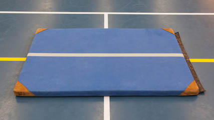 Very old blue mat on a blue court