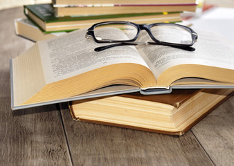 Reading glasses on the opened book
