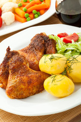 Roasted chicken wings with young potatoes