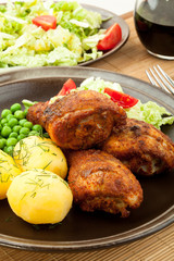 Roasted chicken legs with young potatoes