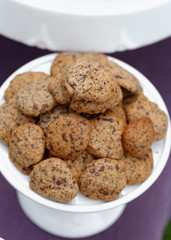 Delicious chocolate chip cookies on table