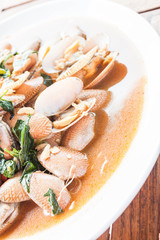 Stir fried clams with roasted chili paste on white plate