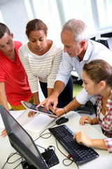 Teacher with students in computing class