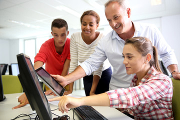 Teacher with students in computing class