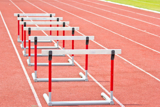 hurdles on the red running track