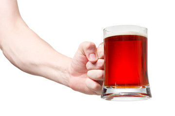Closeup of a male hand holding up a glass of beer over a white b