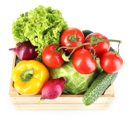Fresh vegetables in wooden box on white background