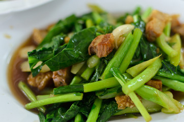 Thai food fried kale with crispy pork