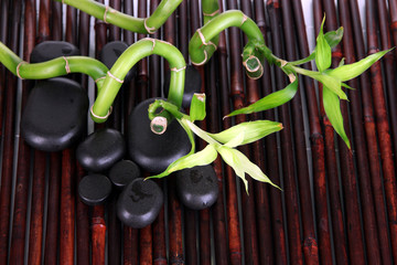 Spa stones and bamboo on bamboo mat background