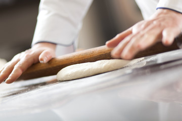Chef preparing dough in the kitchen