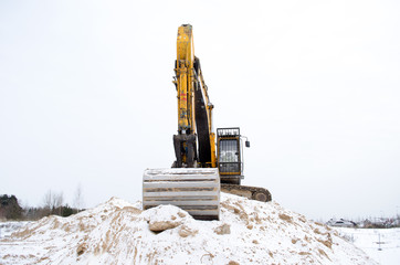 excavator pile sand pit soil snow winter industry