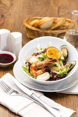 salad with vegetables and seafood on the table in a restaurant