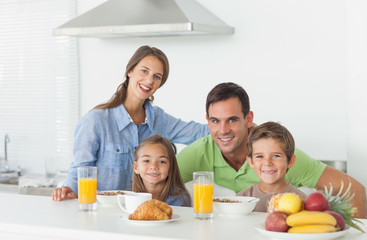 Portrait of cute family having breakfast