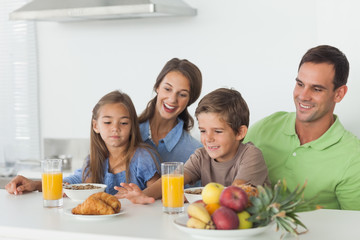 Obraz na płótnie Canvas Parents having breakfast with children