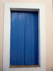 blue wood painted window shutter door in greece