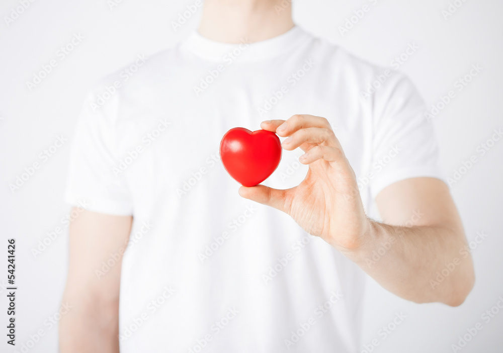 Wall mural man hands with heart