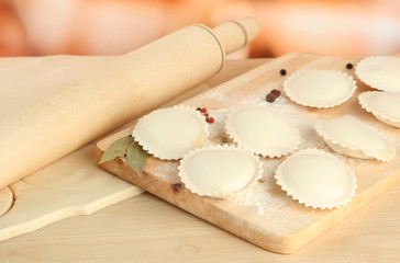 Raw dumplings and dough, on wooden table