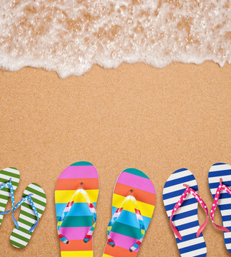 Family's flip flop pairs on sea surf with copy space for your te