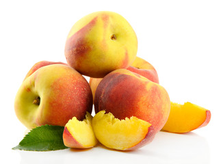 Naklejka na ściany i meble Ripe sweet peaches with leaves, isolated on white