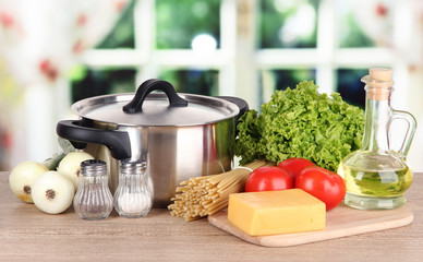 Ingredients for cooking pasta on table in kitchen