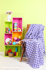 Colorful shelves of different colors with utensils near chair
