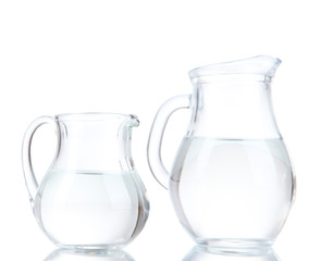 Glass pitchers of water isolated on white