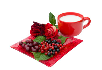 raspberries, currant, cherry,  roses and cup of milk