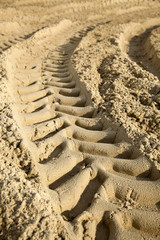 Fototapeta na wymiar Tire Tracks in the Sand - Surface Level