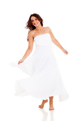 Naklejka premium pretty young woman dancing on white