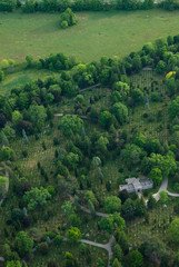 Fototapeta na wymiar Aerial view of a cemetery with tomb and green trees.