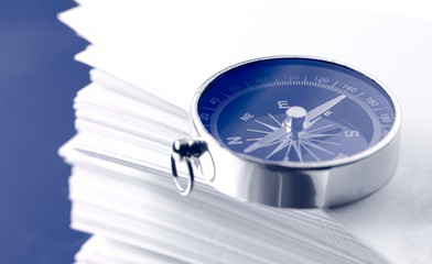 Stack of white cards and compass
