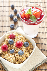 Cereals with blueberries and raspberries, pannacotta on backgrou