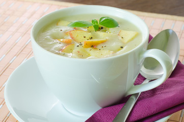 Closeup on a cup with potato and apple soup
