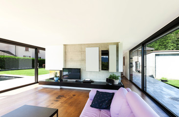 Modern villa, interior, wide living room with pink divan
