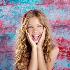 Blond kid girl happy smiling expression hands in face