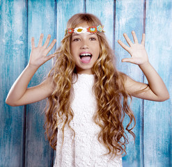 Hippie children girl excited open mouth with raised hands