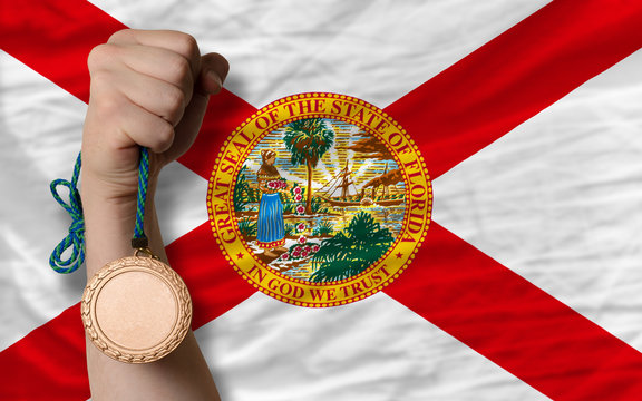 Bronze medal for sport and flag of american state of florida
