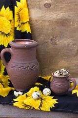 Quail eggs in a cup and a ceramic jug