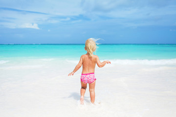 Happy child on the coast of tropical sea