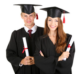 Two happy graduating students isolated on white