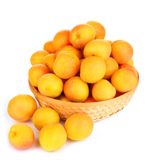 Naklejka na ściany i meble Fresh natural apricot in wicker basket isolated on white