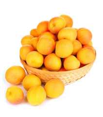 Fresh natural apricot in wicker basket isolated on white