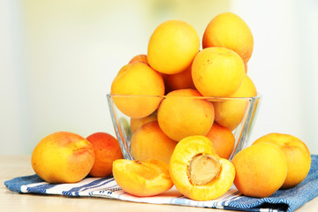 Fresh natural apricot in bowl on table in kitchen