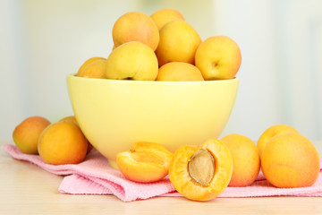 Fresh natural apricot in bowl on table in kitchen