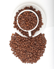 Cup full of coffee beans on white background