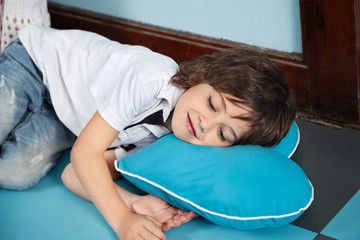 Boy Lying On Heartshaped Pillow In Kindergarten