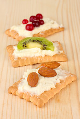 Tasty canapes with cheese, kiwi and cranberry, almond,