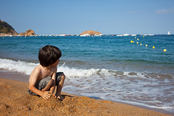 boy on the shore of  sea